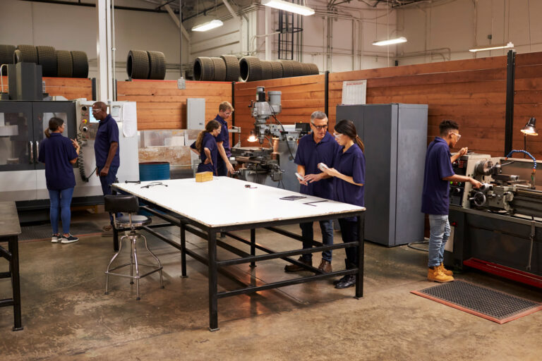 engineers-working-machines-busy-metal-workshop-2